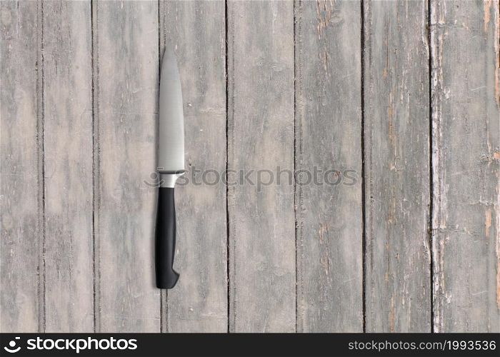 Top up view metal knife on dark wooden vintage table . added copy space for text , suitable for your food or drink concept background.