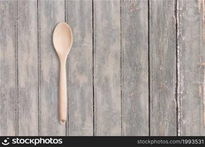 Top up view wooden spoon on dark wooden vintage table . added copy space for text , suitable for your food or drink concept background.