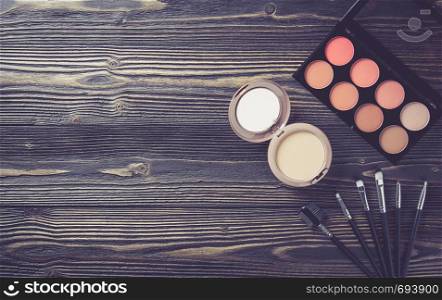 Top view a collection of cosmetic makeup on wooden table background, products cosmetic fashion concept, vintage retro style.