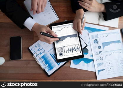 Top view analyst team in office discuss data analysis and marketing strategy using BI dashboard and statistics display on tablet screen to improve business performance at meeting room. Jubilant. Top view analyst team with analysis data on tablet screen. Jubilant