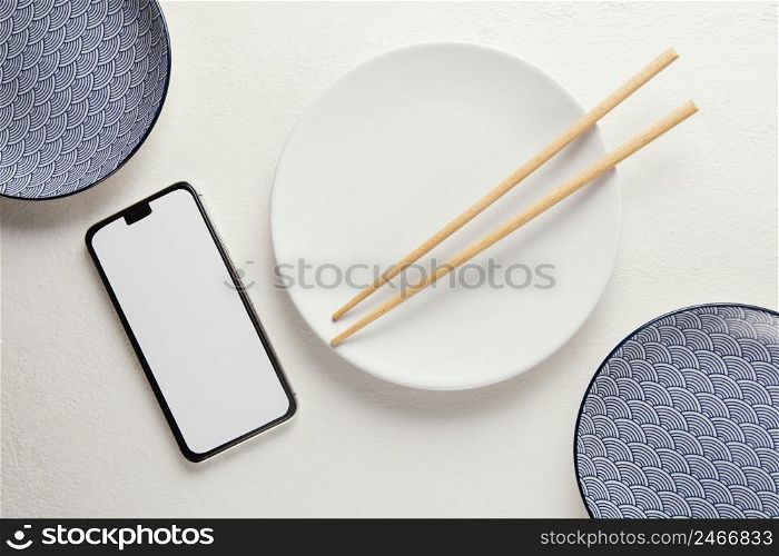 top view arrangement elegant tableware with smartphone