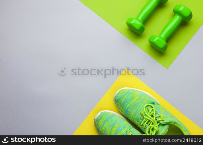 top view arrangement with running shoes dumbbells