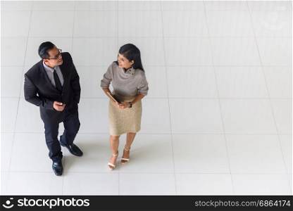 Top view, Asian business people, man and woman, talking about ideas, copy space, selective focus