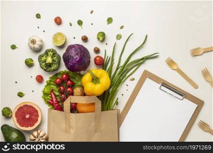 top view assortment vegetables paper bag with clipboard. High resolution photo. top view assortment vegetables paper bag with clipboard. High quality photo
