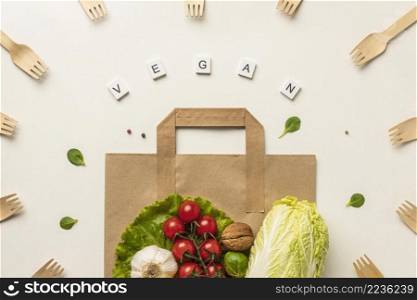 top view assortment vegetables with paper bag word vegan