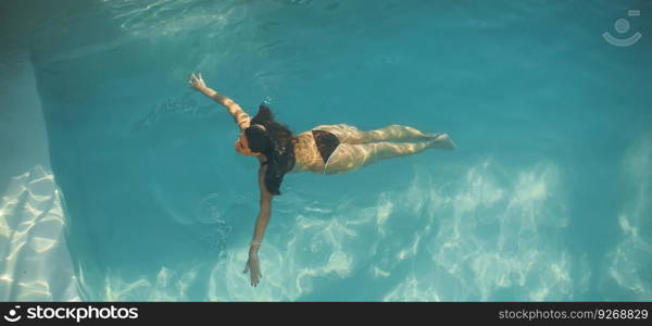 Top view at woman swimming in the pool