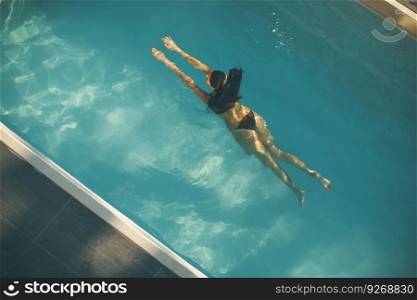 Top view at woman swimming in the pool