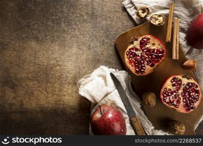 top view autumn pomegranates with copy space cinnamon sticks