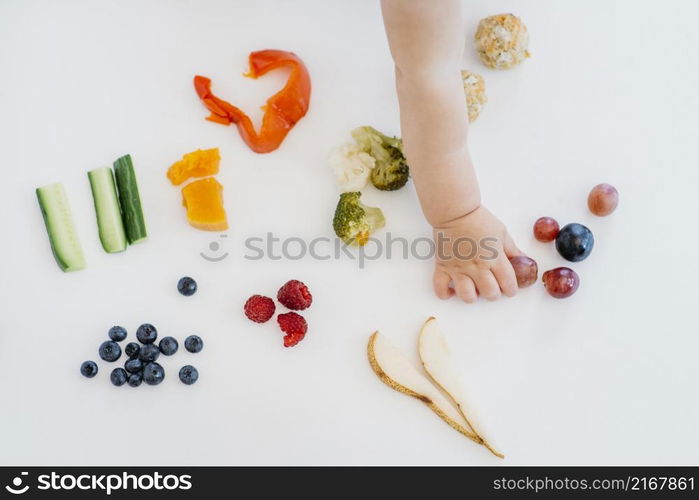 top view baby choosing what eat alone