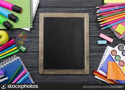 top view back school stationery with colorful pencils blackboard