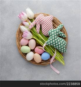 top view basket with easter eggs tulips