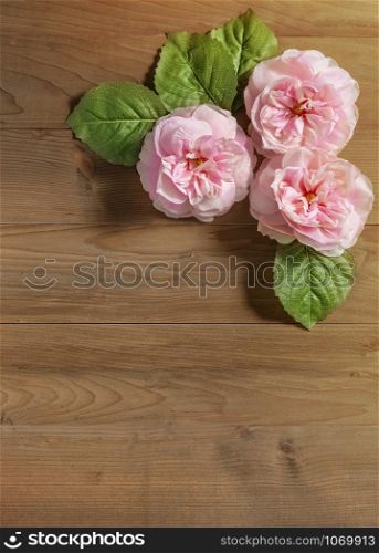 top view beautiful flowers with leaves on wooden background. top view beautiful flowers with leaves