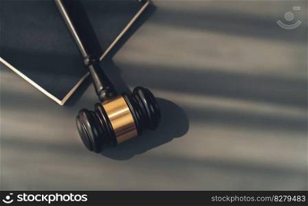 Top view black wooden gavel hammer and law book on wooden office desk background as justice and legal system for lawyer and judge, Legal authority and fairness in trials concept. equility. Top view gavel on wooden office desk background. equility