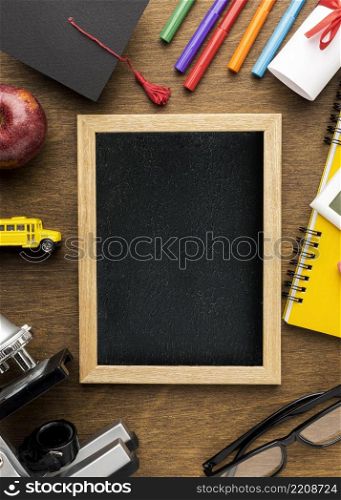 top view blackboard with school supplies