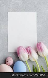 top view blank paper with tulips colorful easter eggs