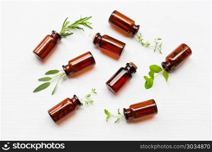 Top view, Bottle of essential oil with herbs . Top view, Bottle of essential oil with herbs on white background.