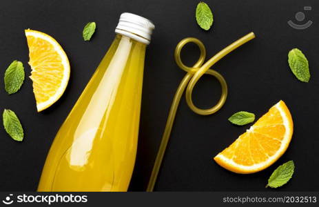 top view bottle with soft drink orange slices