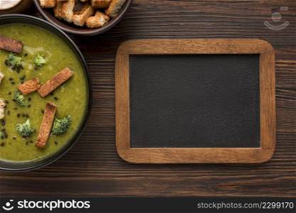top view bowl with winter broccoli soup blackboard