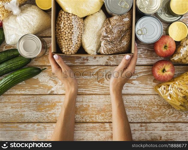 top view box with food donation hands 1. Resolution and high quality beautiful photo. top view box with food donation hands 1. High quality and resolution beautiful photo concept