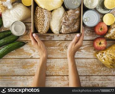 top view box with food donation hands 1. Resolution and high quality beautiful photo. top view box with food donation hands 1. High quality and resolution beautiful photo concept