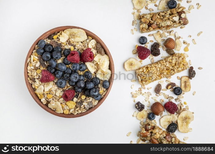 top view breakfast cereal bars with fruits bowl. Resolution and high quality beautiful photo. top view breakfast cereal bars with fruits bowl. High quality and resolution beautiful photo concept