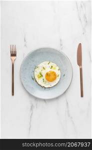 top view breakfast fried egg with cutlery