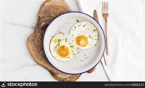 top view breakfast fried eggs plate with cutlery. Resolution and high quality beautiful photo. top view breakfast fried eggs plate with cutlery. High quality beautiful photo concept
