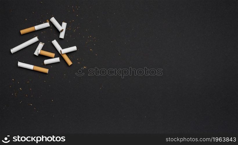 top view broken cigarette with tobacco black backdrop. High resolution photo. top view broken cigarette with tobacco black backdrop. High quality photo