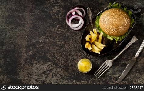top view burger fries with cutlery copy space