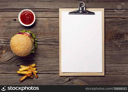 top view burger with mock up clipboard. Resolution and high quality beautiful photo. top view burger with mock up clipboard. High quality and resolution beautiful photo concept
