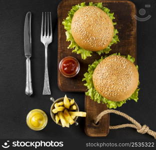 top view burgers fries cutting board