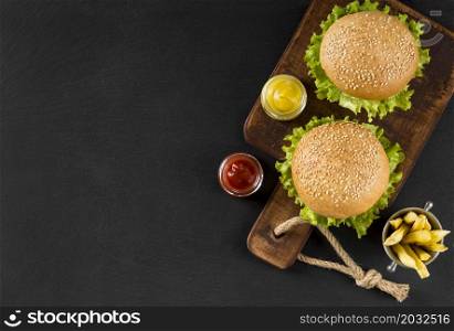 top view burgers fries cutting board with copy space