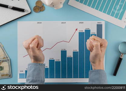 top view business items with growth chart hands fists