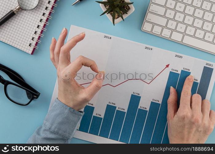 top view business items with growth chart hands giving okay sign. Resolution and high quality beautiful photo. top view business items with growth chart hands giving okay sign. High quality and resolution beautiful photo concept