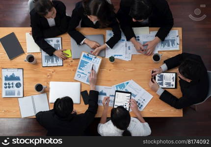 Top-view business team of financial data analysis meeting with business intelligence, report paper and dashboard on laptop for marketing strategy. Business people working together in office of harmony. Business team of financial data analysis meeting report paper in harmony office.