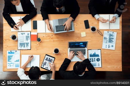 Top-view business team of financial data analysis meeting with business intelligence, report paper and dashboard on laptop for marketing strategy. Business people working together in office of harmony. Business team of financial data analysis meeting report paper in harmony office.