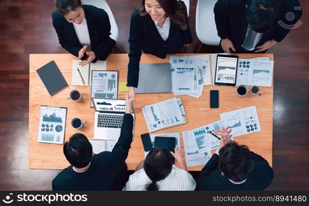 Top-view business team of financial data analysis meeting with business intelligence, report paper and dashboard on laptop for marketing strategy. Business people working together in office of harmony. Business team of financial data analysis meeting report paper in harmony office.