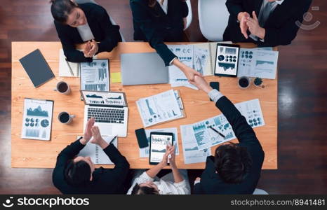 Top-view business team of financial data analysis meeting with business intelligence, report paper and dashboard on laptop for marketing strategy. Business people working together in office of harmony. Business team of financial data analysis meeting report paper in harmony office.