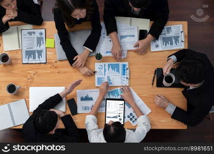 Top-view business team of financial data analysis meeting with business intelligence, report paper and dashboard on laptop for marketing strategy. Business people working together in office of harmony. Business team of financial data analysis meeting report paper in harmony office.