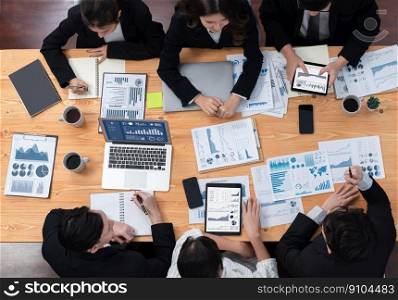 Top-view business team of financial data analysis meeting with business intelligence, report paper and dashboard on laptop for marketing strategy. Business people working together in office of harmony. Business team of financial data analysis meeting report paper in harmony office.