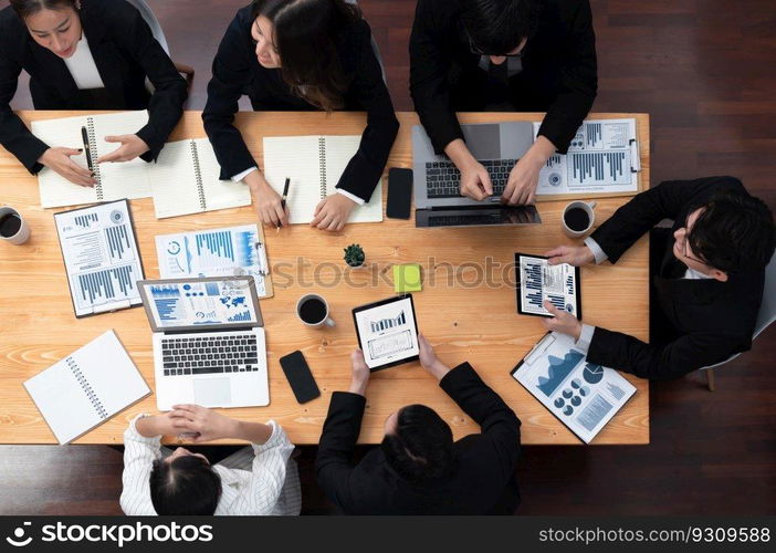 Top-view business team of financial data analysis meeting with business intelligence, report paper and dashboard on laptop for marketing strategy. Business people working together in office of harmony. Business team of financial data analysis meeting report paper in harmony office.