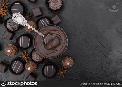 top view candies melted chocolate with copy space