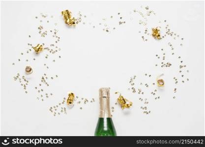 top view champagne bottle with golden ribbons confetti
