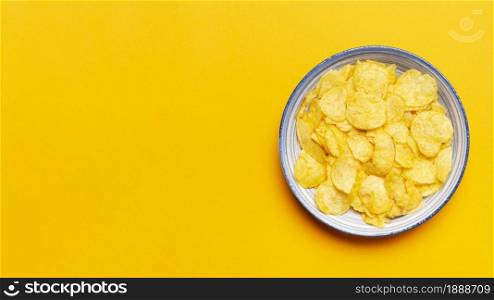 top view chips bowl yellow background. Resolution and high quality beautiful photo. top view chips bowl yellow background. High quality and resolution beautiful photo concept