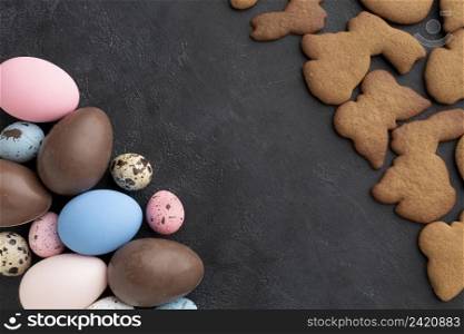 top view chocolate easter eggs with bunny shaped cookies