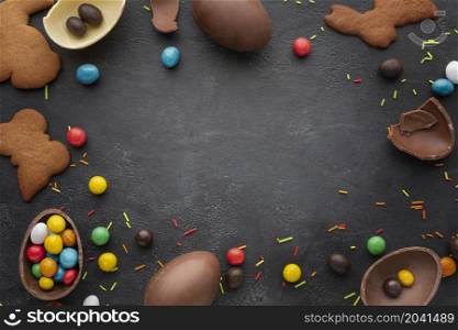 top view chocolate easter eggs with candy cookies frame