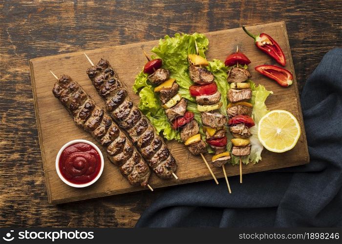 top view chopping board with delicious kebab lemon. Resolution and high quality beautiful photo. top view chopping board with delicious kebab lemon. High quality beautiful photo concept