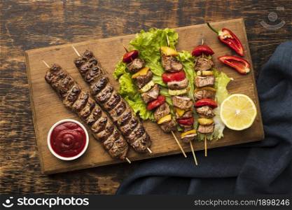 top view chopping board with delicious kebab lemon. Resolution and high quality beautiful photo. top view chopping board with delicious kebab lemon. High quality beautiful photo concept