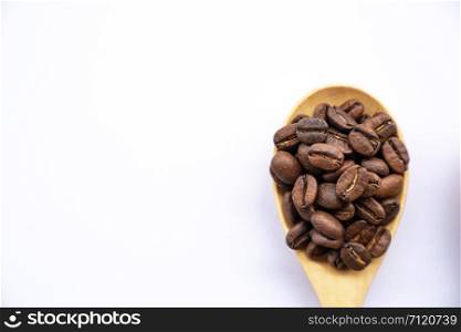 top view close up coffee bean on wooden spoon on white background with copy space
