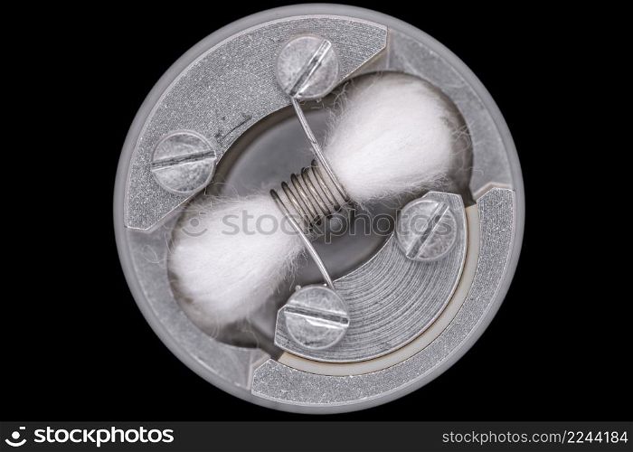 top view, close up, macro shot of single space coil with japanese organic cotton wick in high end rebuildable dripping atomizer for flavour chaser isolated on black background, vaping device